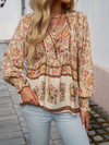 Bohemian lace-up V-neck blouse for women with vibrant print, lantern sleeves, and loose fit, perfect for spring and summer.