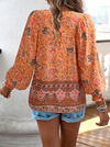 Bohemian lace-up V-neck blouse for women with vibrant print, lantern sleeves, and loose fit, perfect for spring and summer.