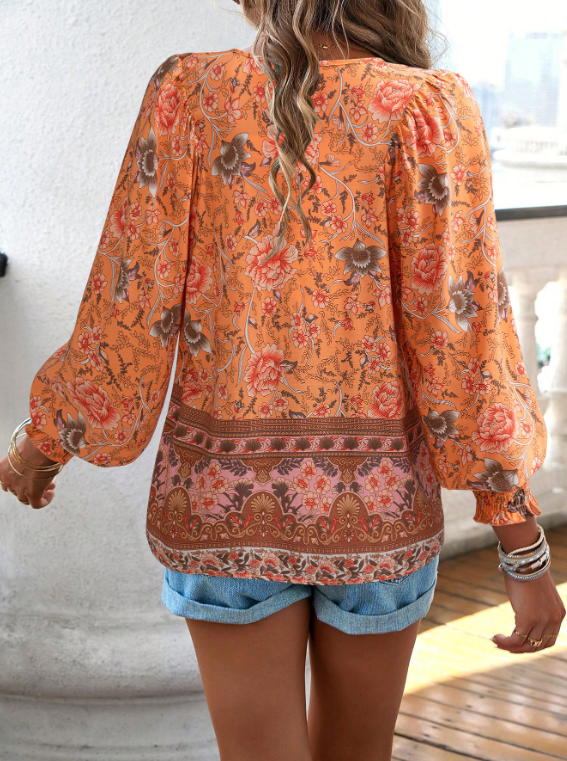 Bohemian lace-up V-neck blouse for women with vibrant print, lantern sleeves, and loose fit, perfect for spring and summer.