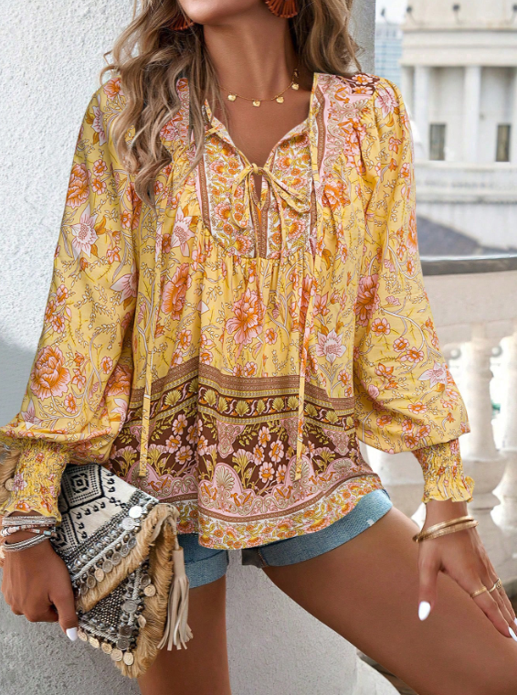 Bohemian lace-up V-neck blouse for women with vibrant print, lantern sleeves, and loose fit, perfect for spring and summer.