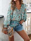 Bohemian lace-up V-neck blouse for women in vibrant print, featuring lantern sleeves and a loose fit, perfect for spring and