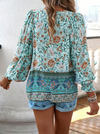 Bohemian lace-up V-neck blouse for women with vibrant print, lantern sleeves, and loose fit, perfect for spring and summer.