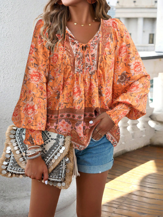 Bohemian lace-up V-neck blouse for women with vibrant print, lantern sleeves, and loose fit, perfect for spring and summer.