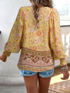 Bohemian lace-up V-neck blouse for women with vibrant print, lantern sleeves, and loose fit, perfect for spring and summer.