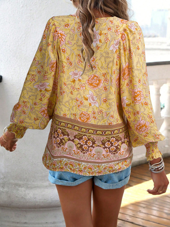 Bohemian lace-up V-neck blouse for women with vibrant print, lantern sleeves, and loose fit, perfect for spring and summer.