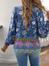 Bohemian Lace-Up V-Neck Blouse for women in vibrant print, featuring lantern sleeves and a loose fit, perfect for spring and