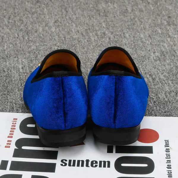 Men's slip-on velvet loafers with a sophisticated gold toe.
