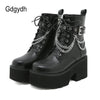 Edgy black platform ankle boots with statement metal chain and zip closure