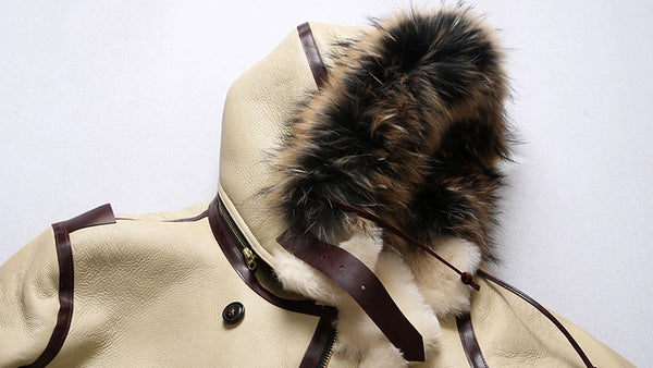Luxury men's shearling leather bomber jacket in a winter setting.