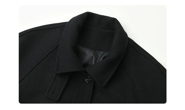 Refined belted woolen coat with single-breasted front and turtleneck collar