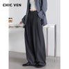 Elegant high-waisted pleated trousers with loose wide leg silhouette and drawstring closure