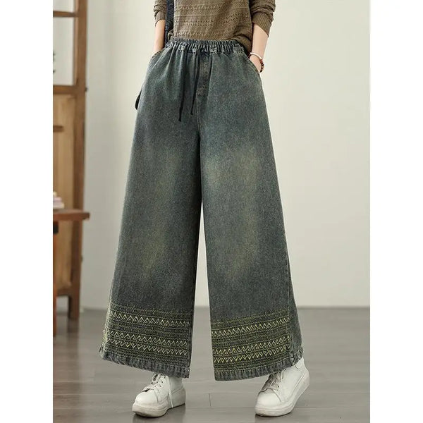 Vintage embroidered wide-leg jeans for women in light wash, featuring elastic waist and ethnic-inspired designs. Perfect for