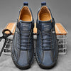Close-up of handcrafted leather loafer showing detailed artisan stitching and supple genuine leather texture