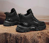 Black suede boots with essential stitching details for a sleek look.