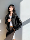Chic vintage leather cropped jacket for women styled for a formal event.
