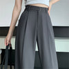 Black high-waist wide leg trousers with flowing silhouette on white background