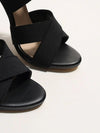 Chic red ankle-wrap stiletto heels with a sleek open-toe design.