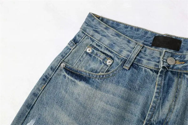 Trendy washed and ripped wide-leg women's jeans with distressed ink-splashed finish for a chic, casual look.