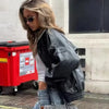 Chic black faux leather moto jacket for women, perfect for autumn evenings and stylish casual wear with functional pockets.
