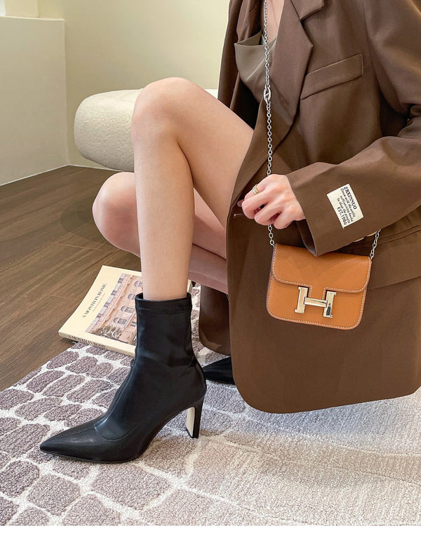 Chic black ankle boots with slim high heels, pointed toe design, perfect for autumn and winter fashion. Stylish women's footw