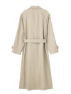 Belted trench coat styled over casual outfit for versatile fall fashion