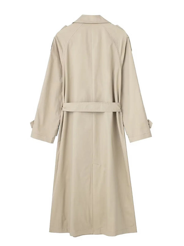 Belted trench coat styled over casual outfit for versatile fall fashion