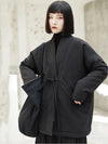 Side view of oversized winter jacket featuring adjustable belt and spacious pocket design