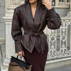 Chic belted leather bomber jacket for women, featuring lace-up detail, notched lapel, and hood for stylish autumn wear.