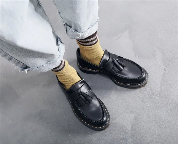 Black tassel loafers designed for modern men's fashion.