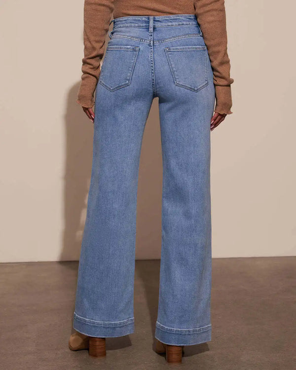 Chic high-waisted wide-leg jeans for women, featuring a relaxed fit, distressed details, and practical pockets for stylish co