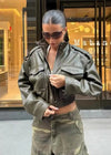 Chic army green faux leather jacket for women with stand collar, loose fit, and functional pockets, perfect for winter style.