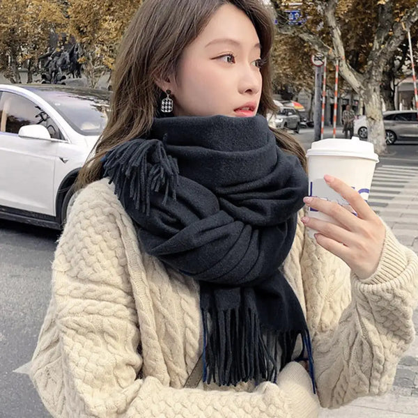 Elegant black cashmere blend winter scarf for women with tassel trim.