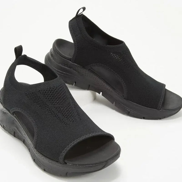 Detail of cloud-like soft mesh material and open toe design on wedge platform sandals