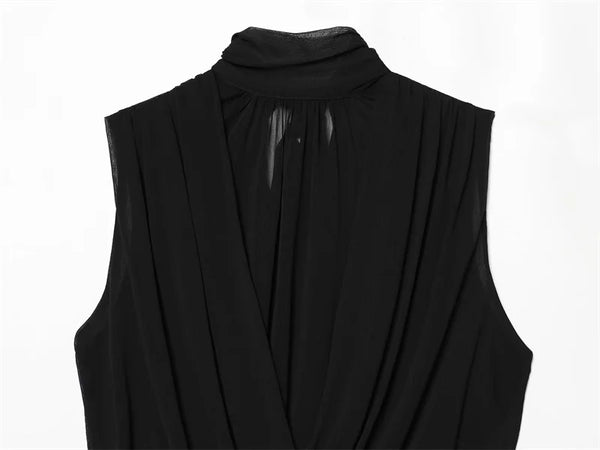 Women's sleeveless black top with vertical pleats and ribbon embellishment