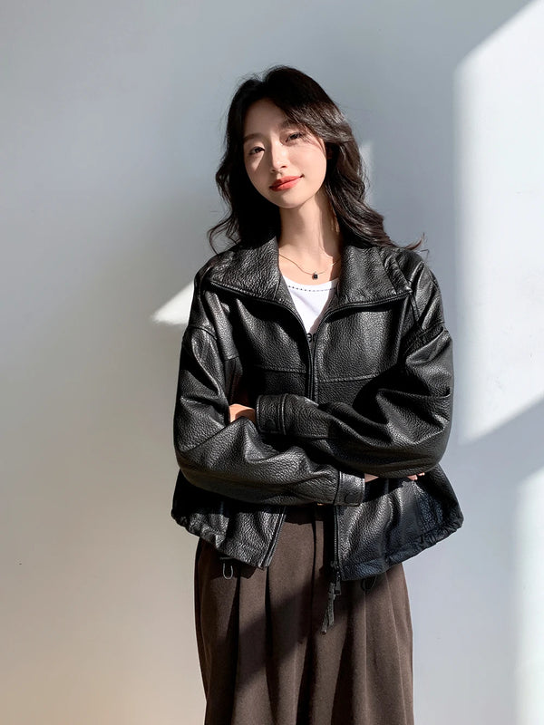 Close-up of the luxurious leather texture on the cropped jacket for women.