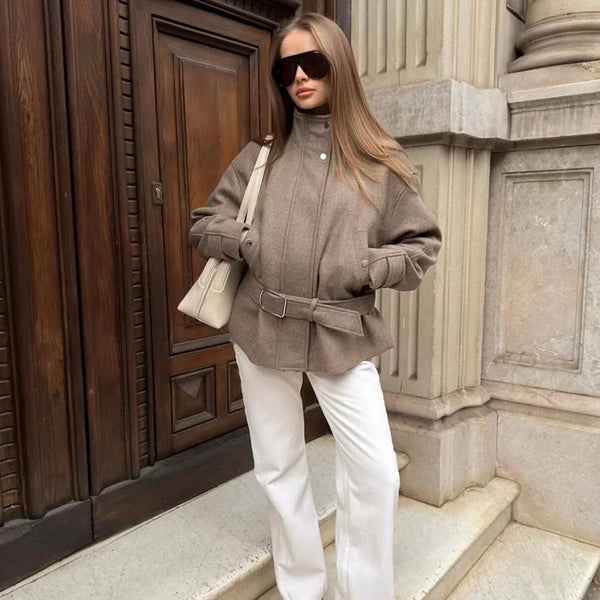Women's belted autumn jacket with turtleneck and zip-front closure draped on model