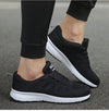 White running sneakers featuring mesh construction and vibrant details