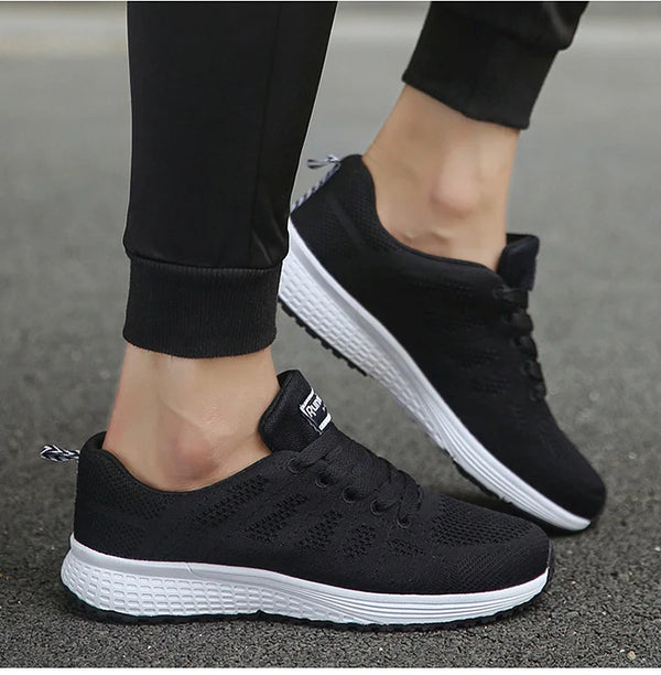 White running sneakers featuring mesh construction and vibrant details