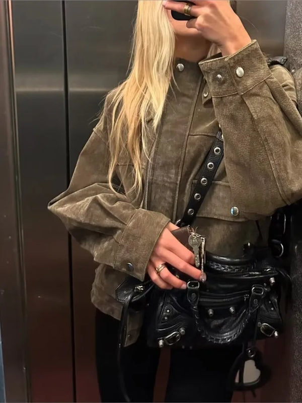 Chic women's leather jacket with button closure, lapel collar, and short length for stylish urban fashion and versatility.