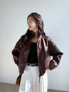 Close-up of the high-end design of the chic vintage leather cropped jacket.