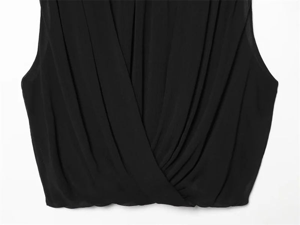 Elegant black pleated top with feminine ribbon detail for spring and summer