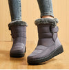 Chic women's waterproof winter boots with plush lining, low heel, and hook-and-loop closure for stylish cold weather comfort.