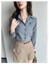 Chic striped blouse for office elegance, featuring a turn-down collar and single-breasted closure, perfect for professional w