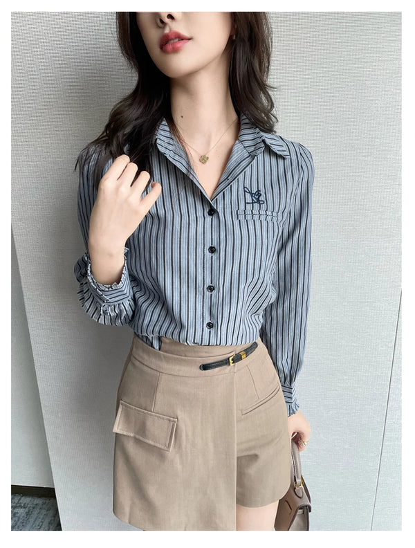 Chic striped blouse for office elegance, featuring a turn-down collar and single-breasted closure, perfect for professional w