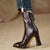 Black glossy ankle boots featuring square toe silhouette and metal details