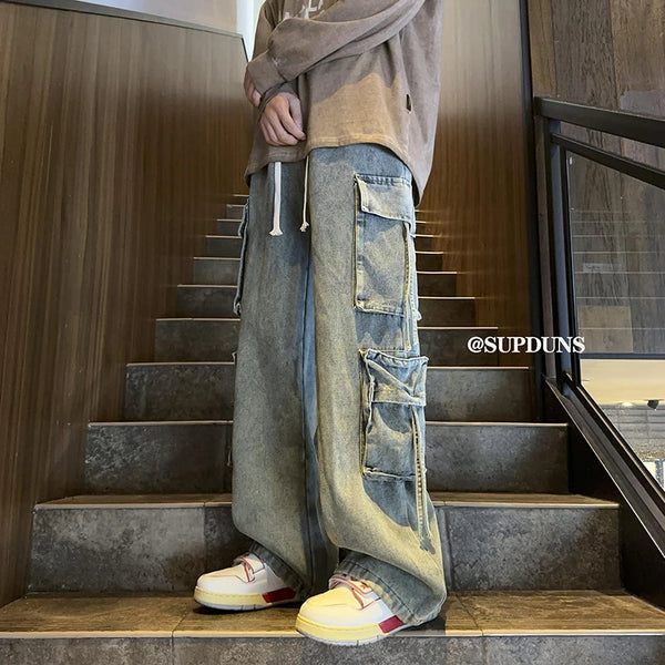 Men's wide-leg hip-hop jeans in black coated denim with drawstring waist.