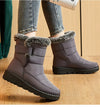 Chic women's waterproof winter boots with plush lining, low heel, and hook-and-loop closure for stylish cold weather comfort.
