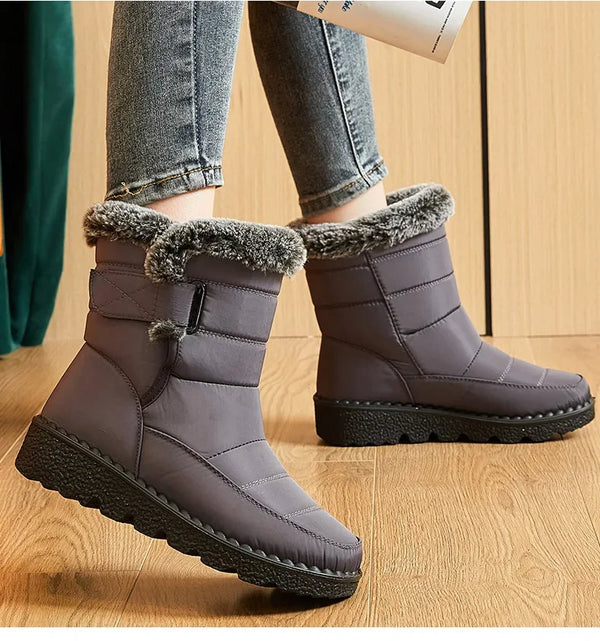 Chic women's waterproof winter boots with plush lining, low heel, and hook-and-loop closure for stylish cold weather comfort.
