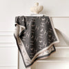 Chic winter accessory: cashmere shawl with artistic floral details.