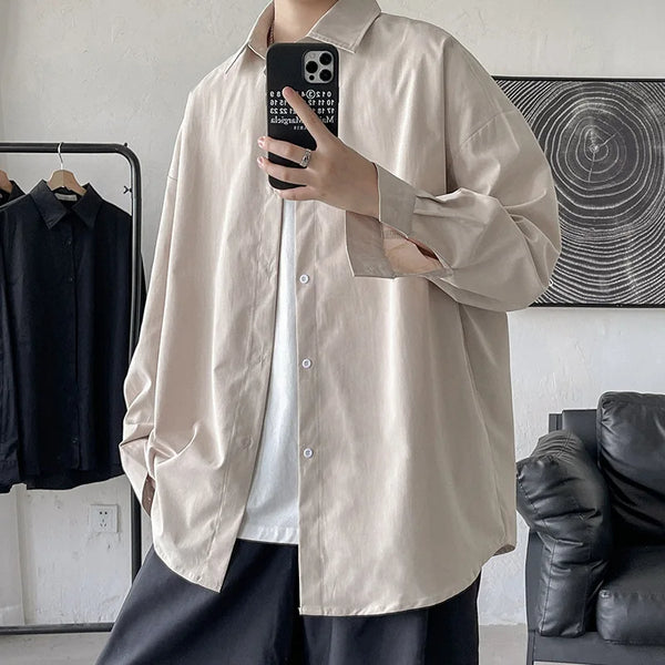 Oversized long sleeve casual shirt for men and women, featuring a Mandarin collar and single-breasted closure in solid color.